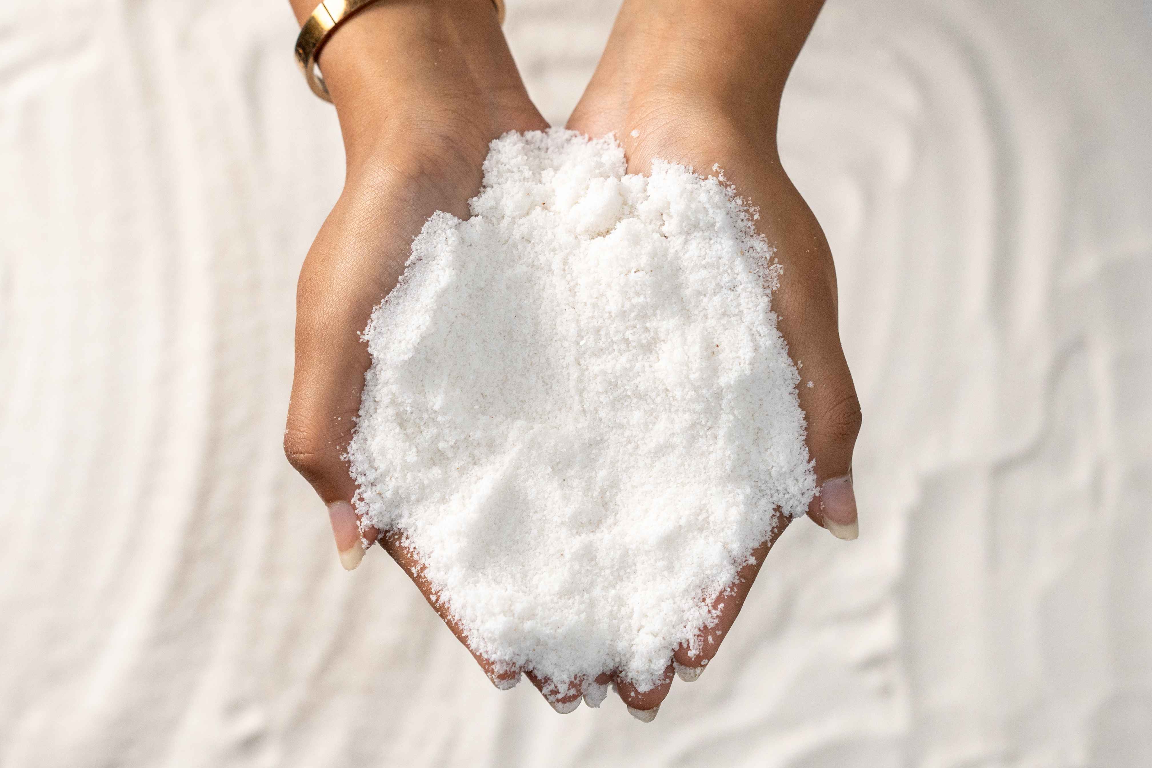 Hands holding Ankur Salt for Eva Chemlinks.