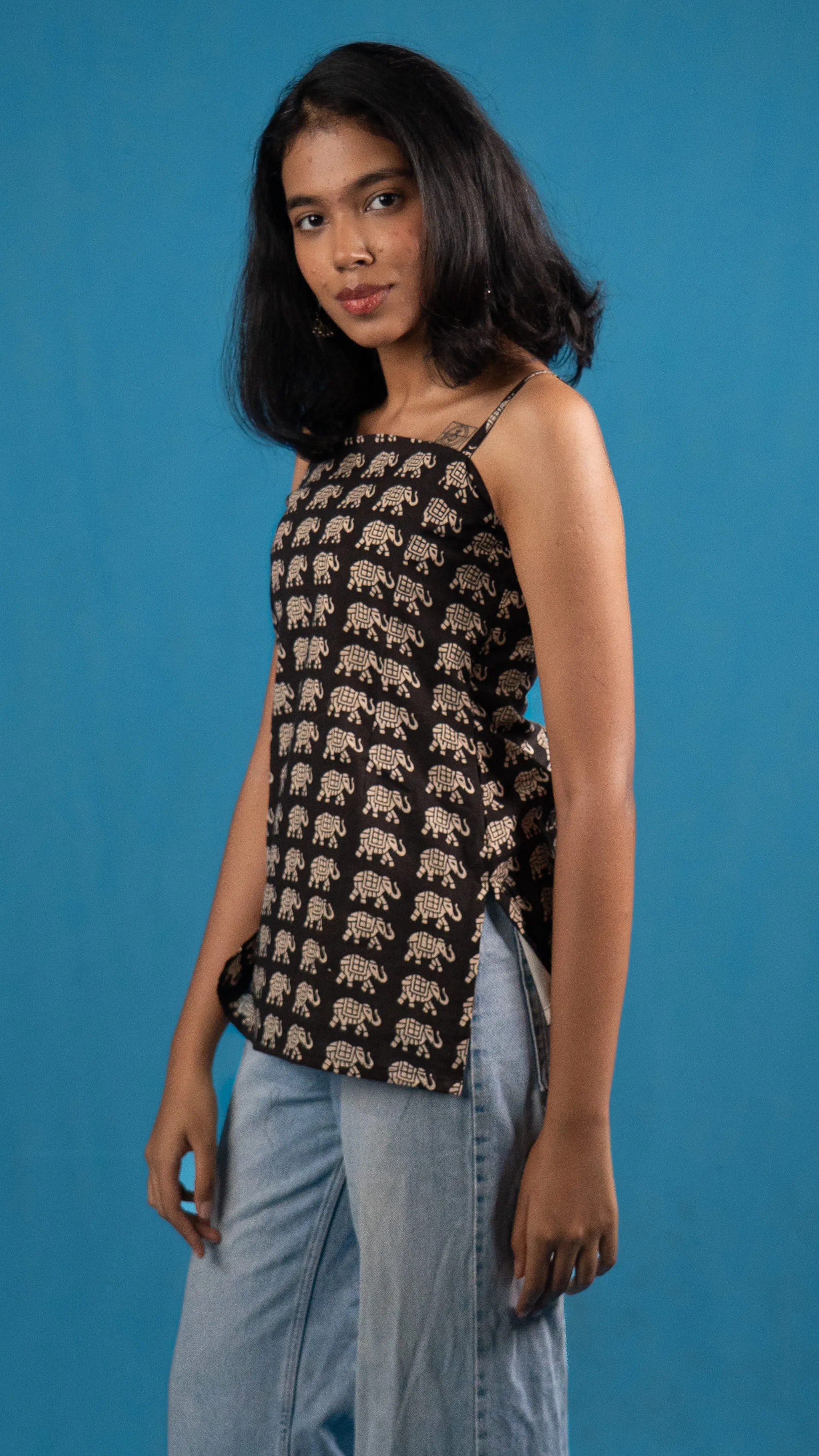 Three-quarter portrait of a black elephant-print top for Indyvarna.