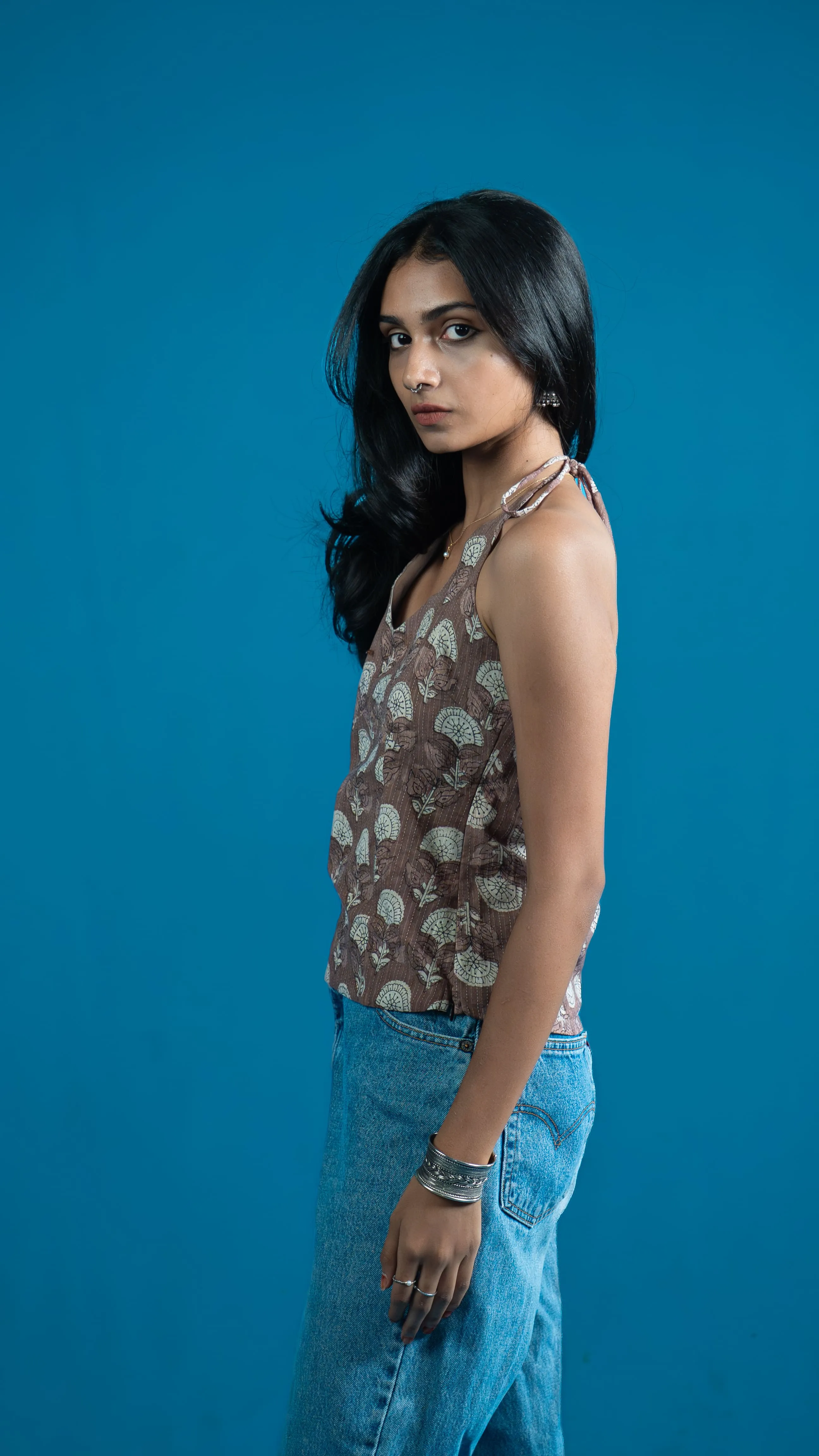 Side view of a brown floral halter-style top for Indyvarna.