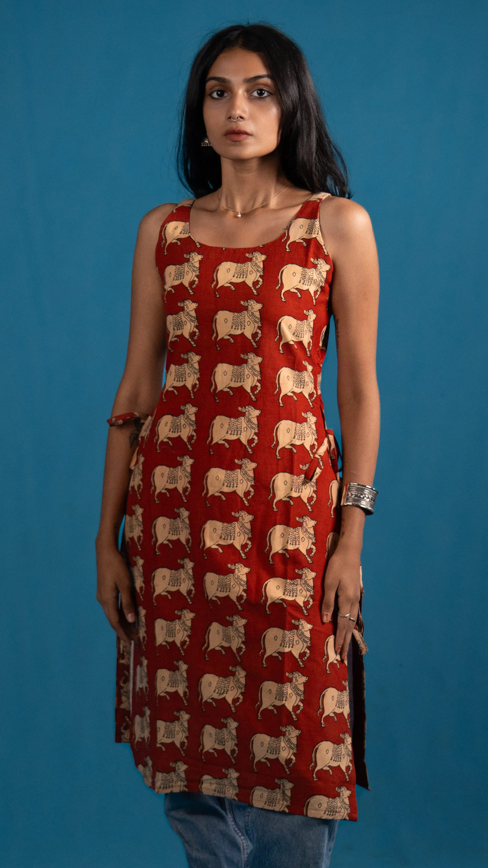 Woman in a red cow-print sleeveless top for Indyvarna's collection photography.