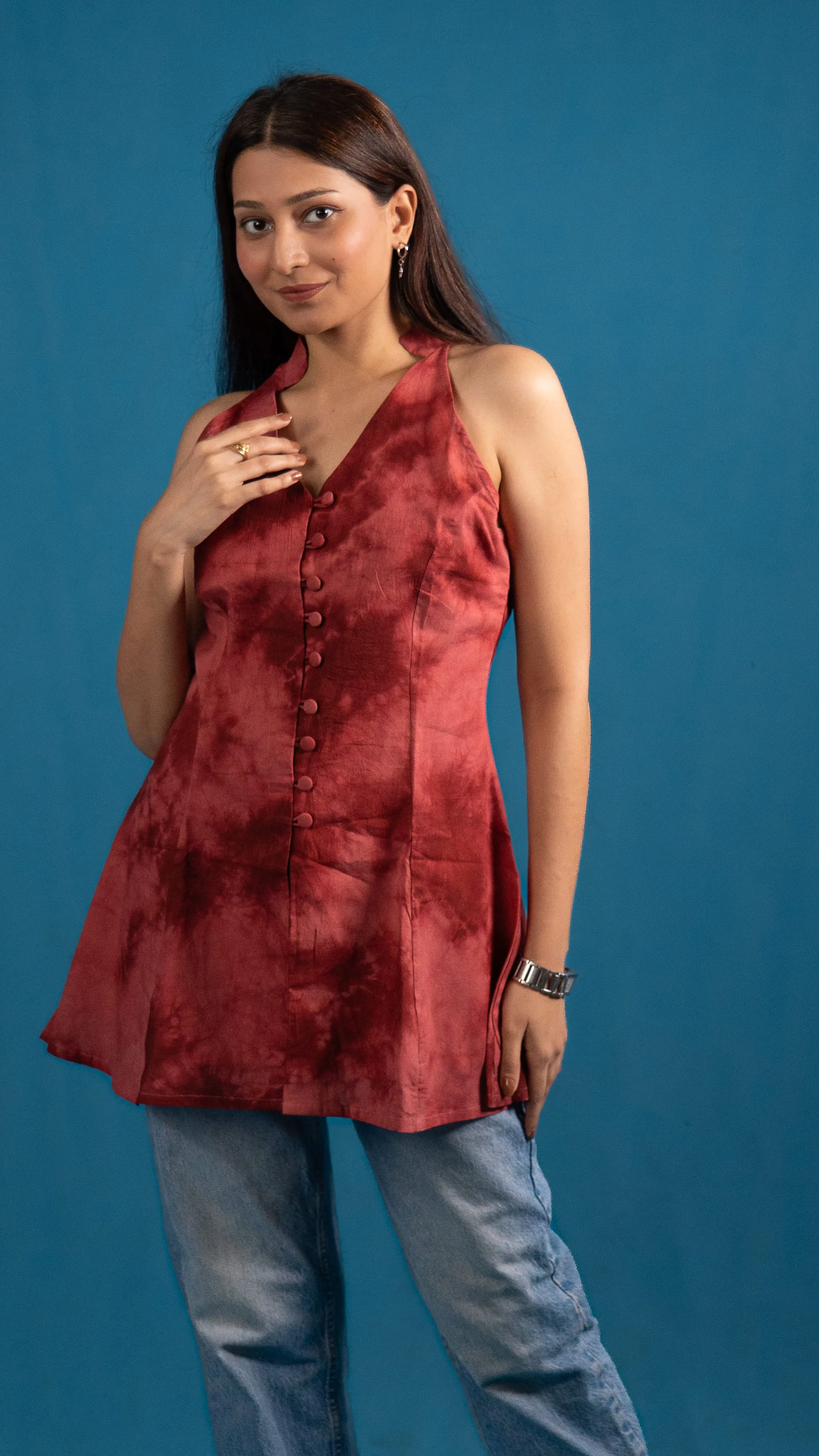 Woman in a red tie-dye sleeveless longline top for Indyvarna's collection photography.