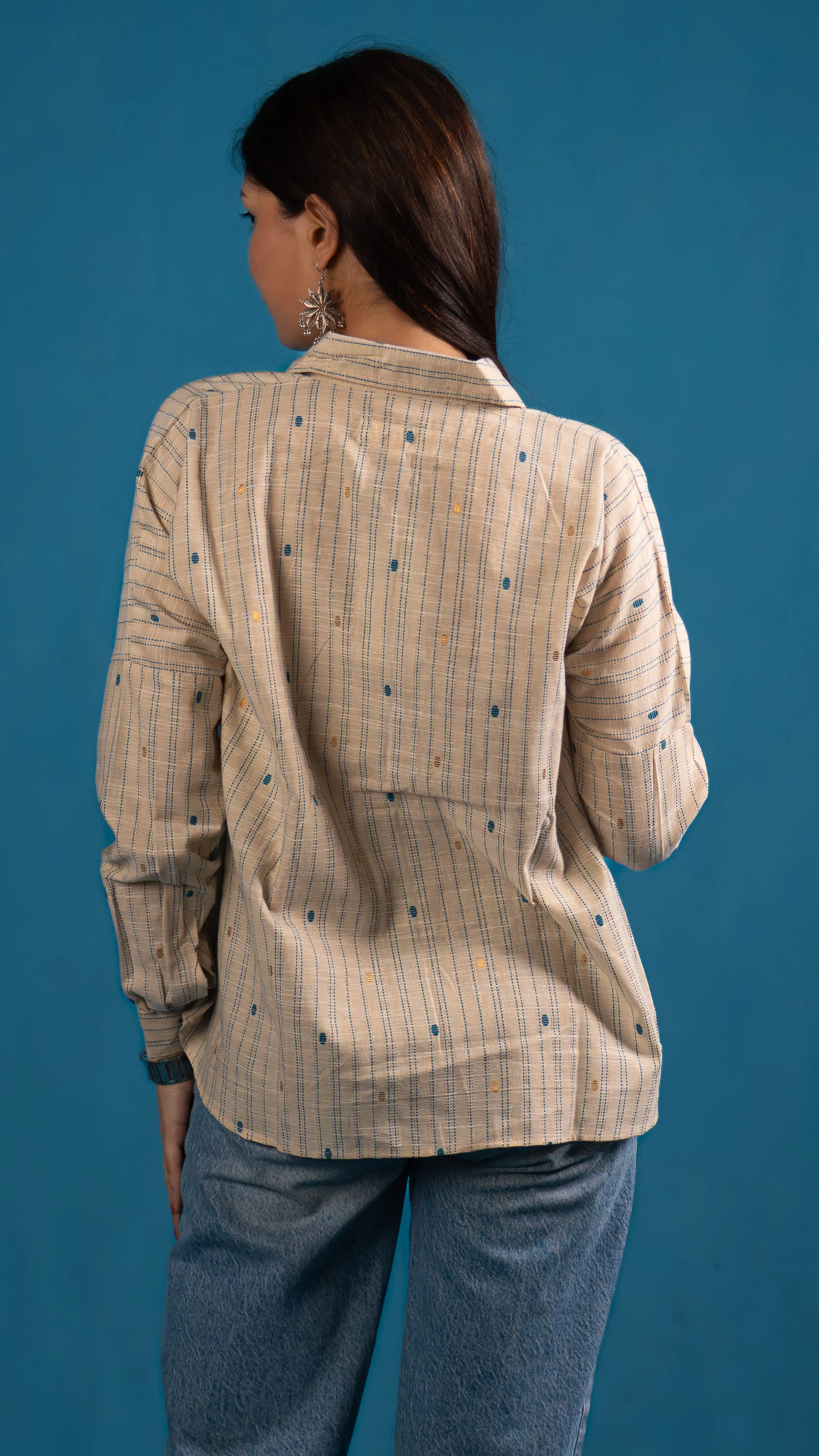 Back view of a cream striped button-up shirt for Indyvarna's collection photography.