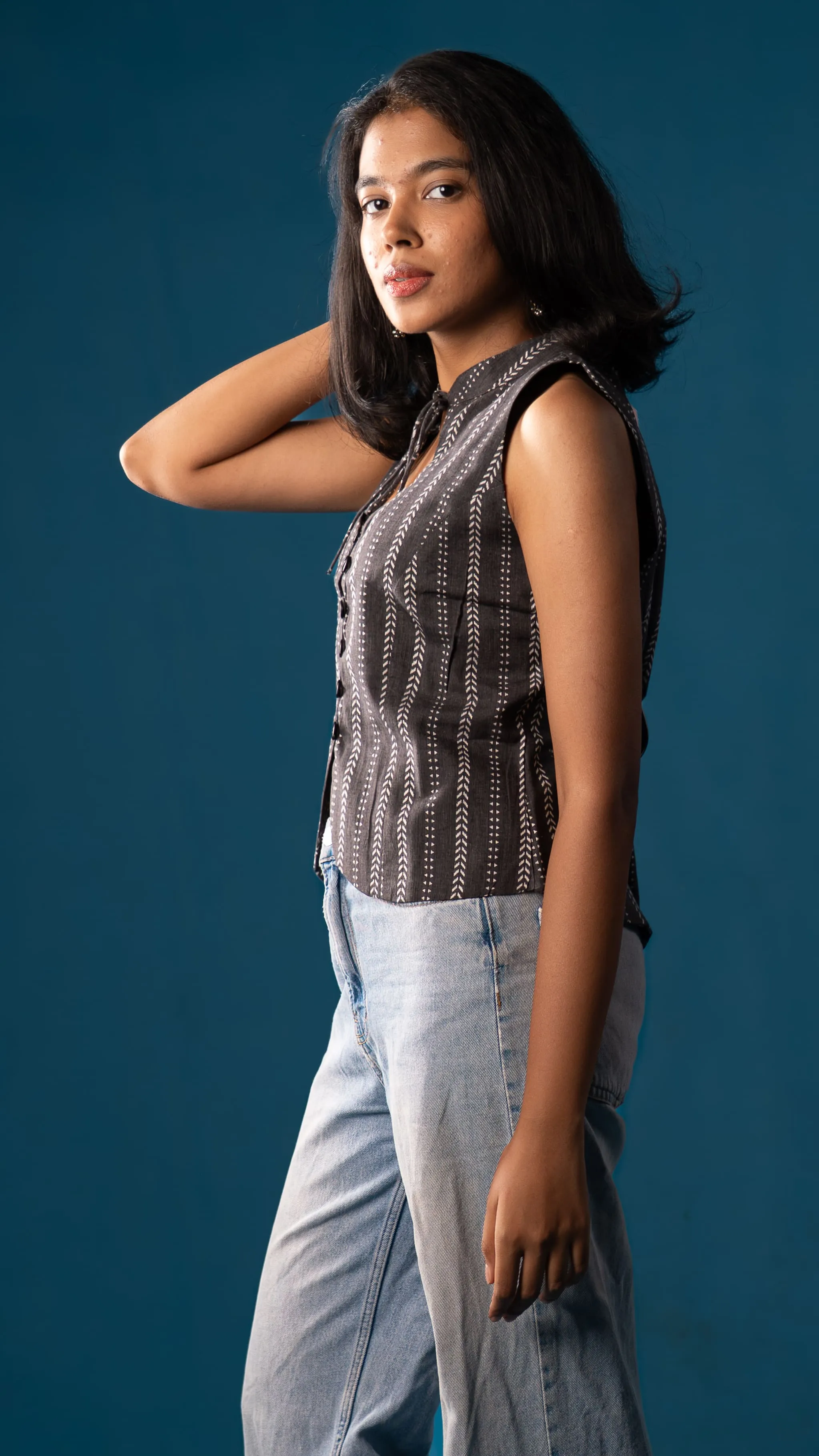 Woman in a black sleeveless patterned top for Indyvarna's collection photography.