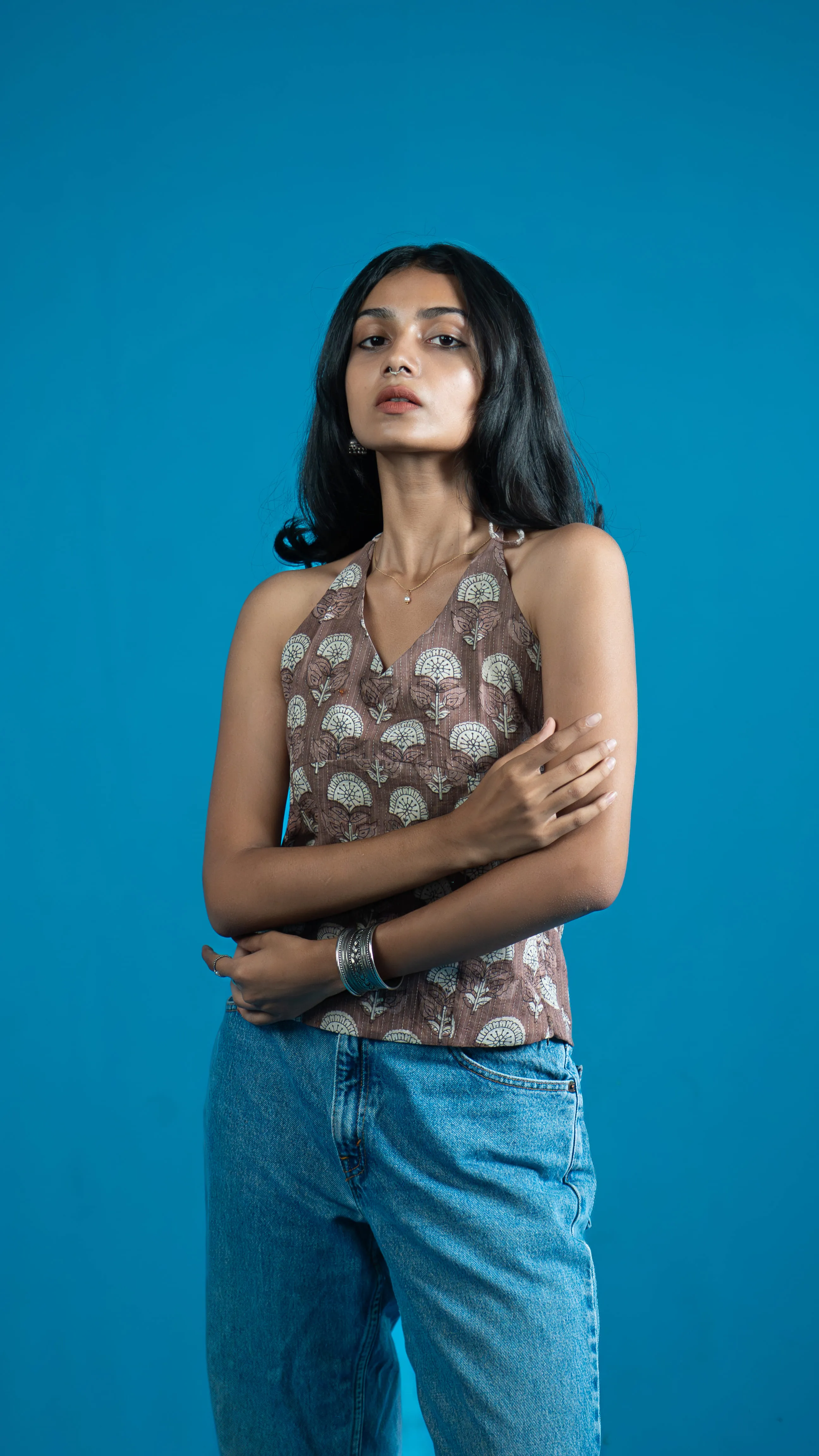 Woman in a brown floral halter-style top for Indyvarna's collection photography.