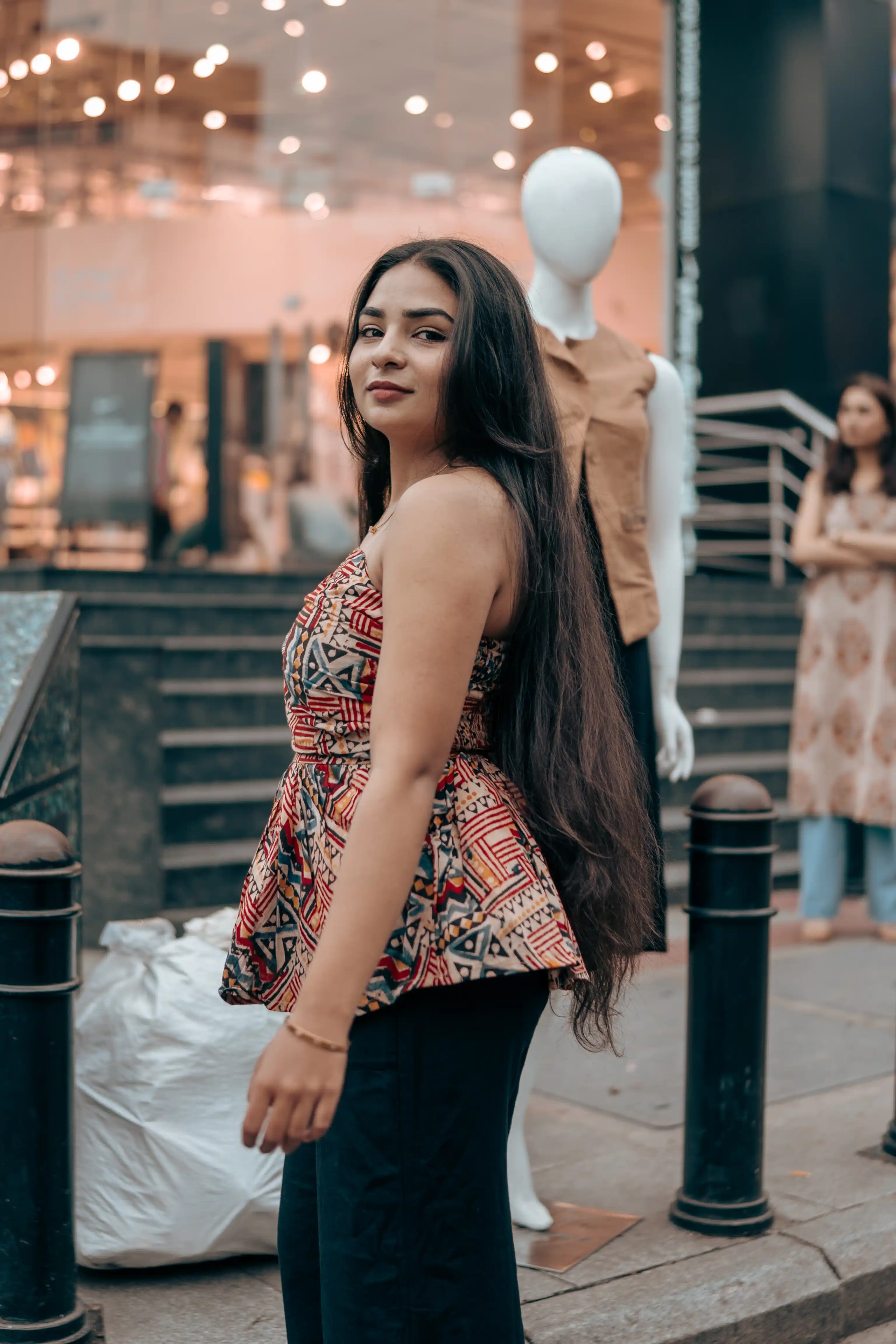 Woman in a multicoloured patterned peplum top for Indyvarna.