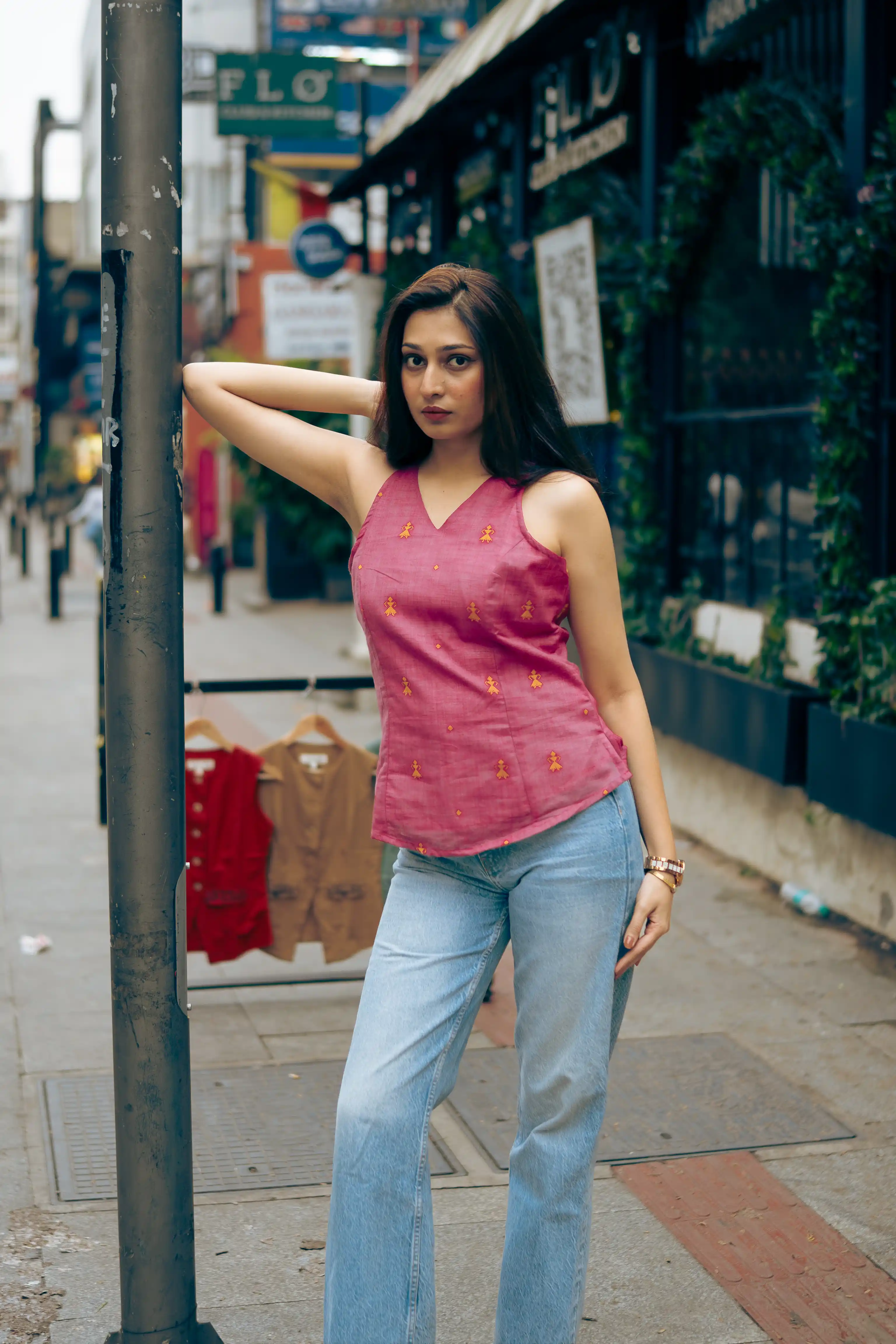 Woman in a magenta sleeveless top with yellow motifs for Indyvarna.