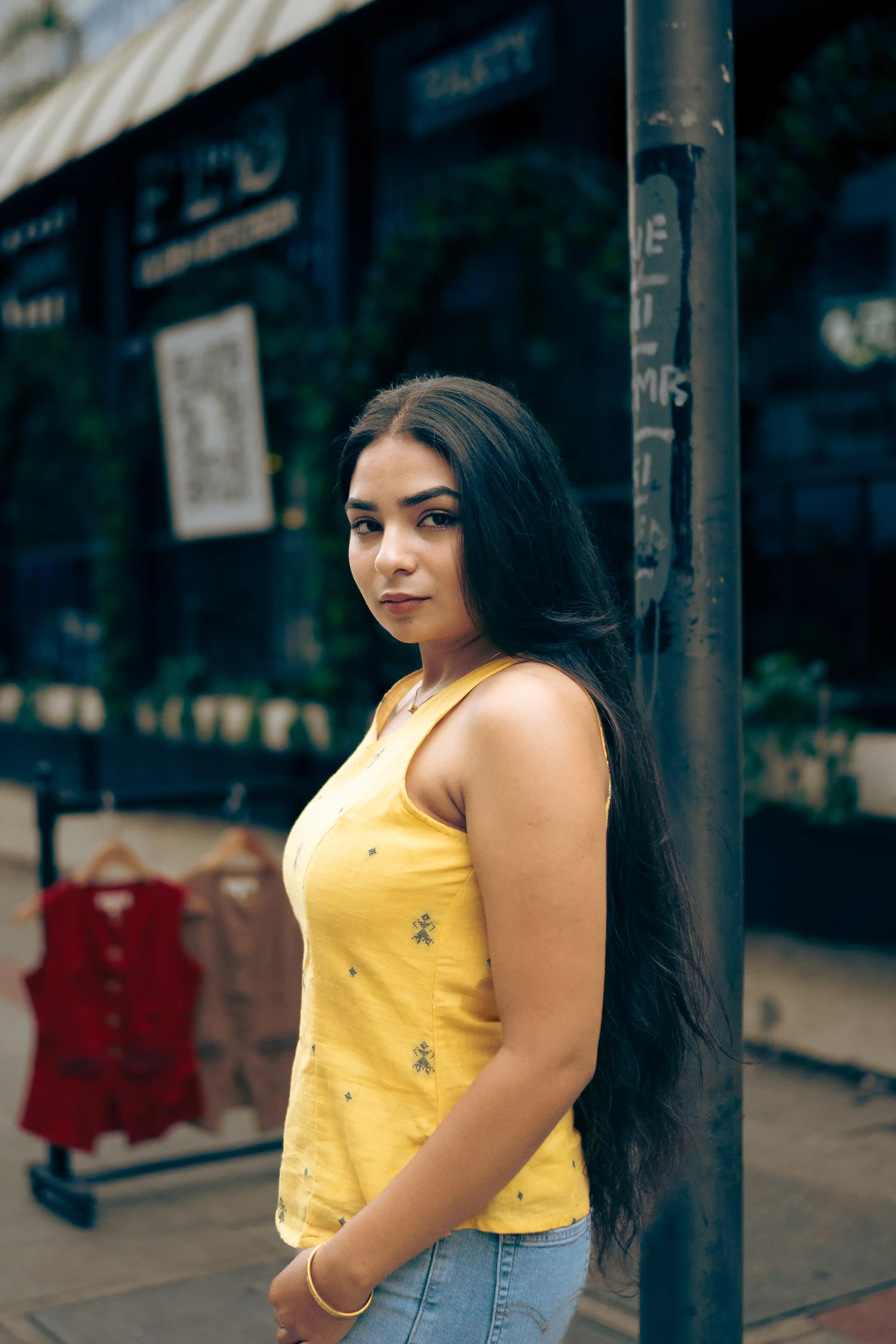 Woman in a magenta sleeveless top with yellow motifs for Indyvarna.