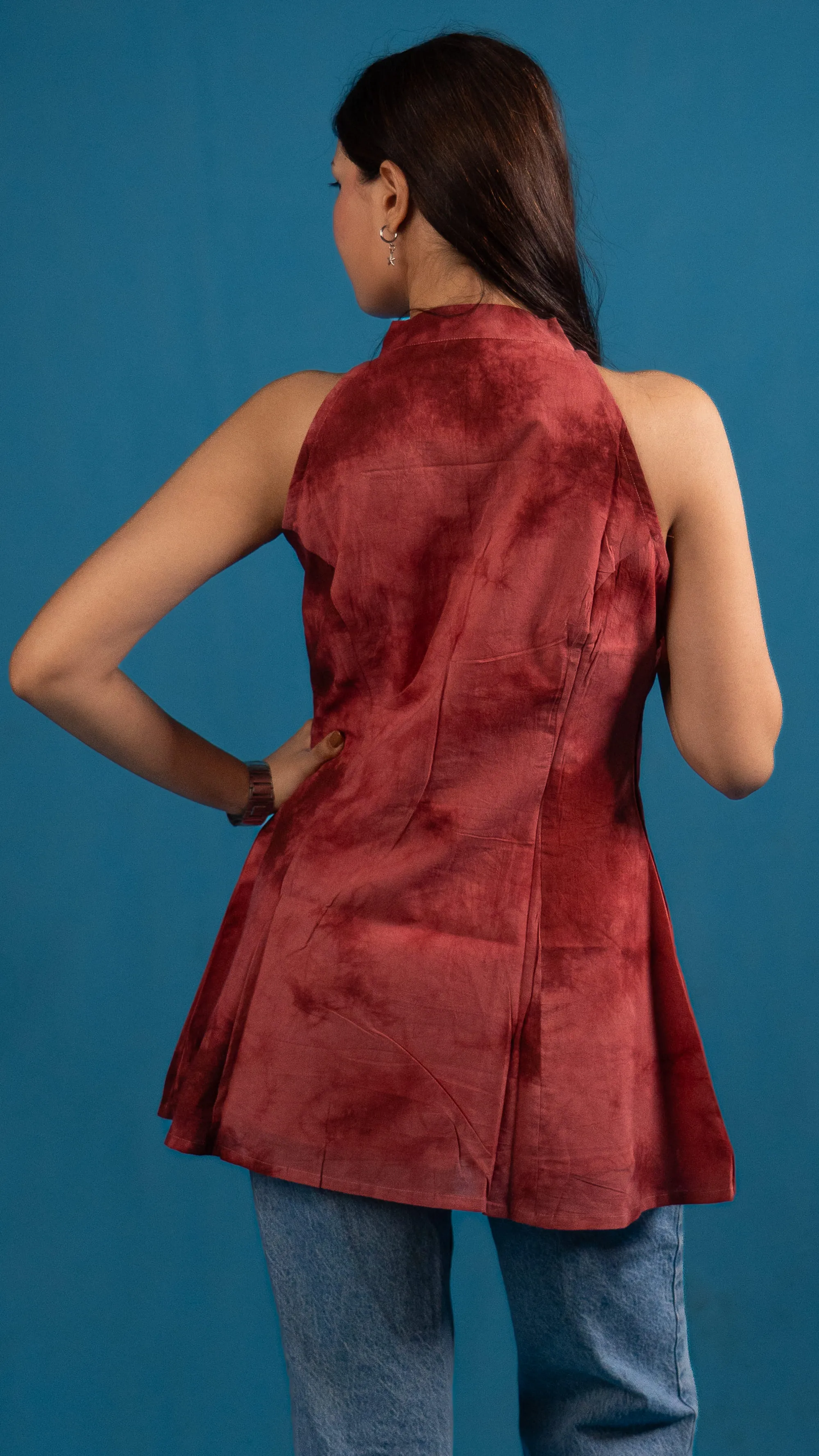 Three-quarter portrait of a woman in a red tie-dye sleeveless top for Indyvarna.