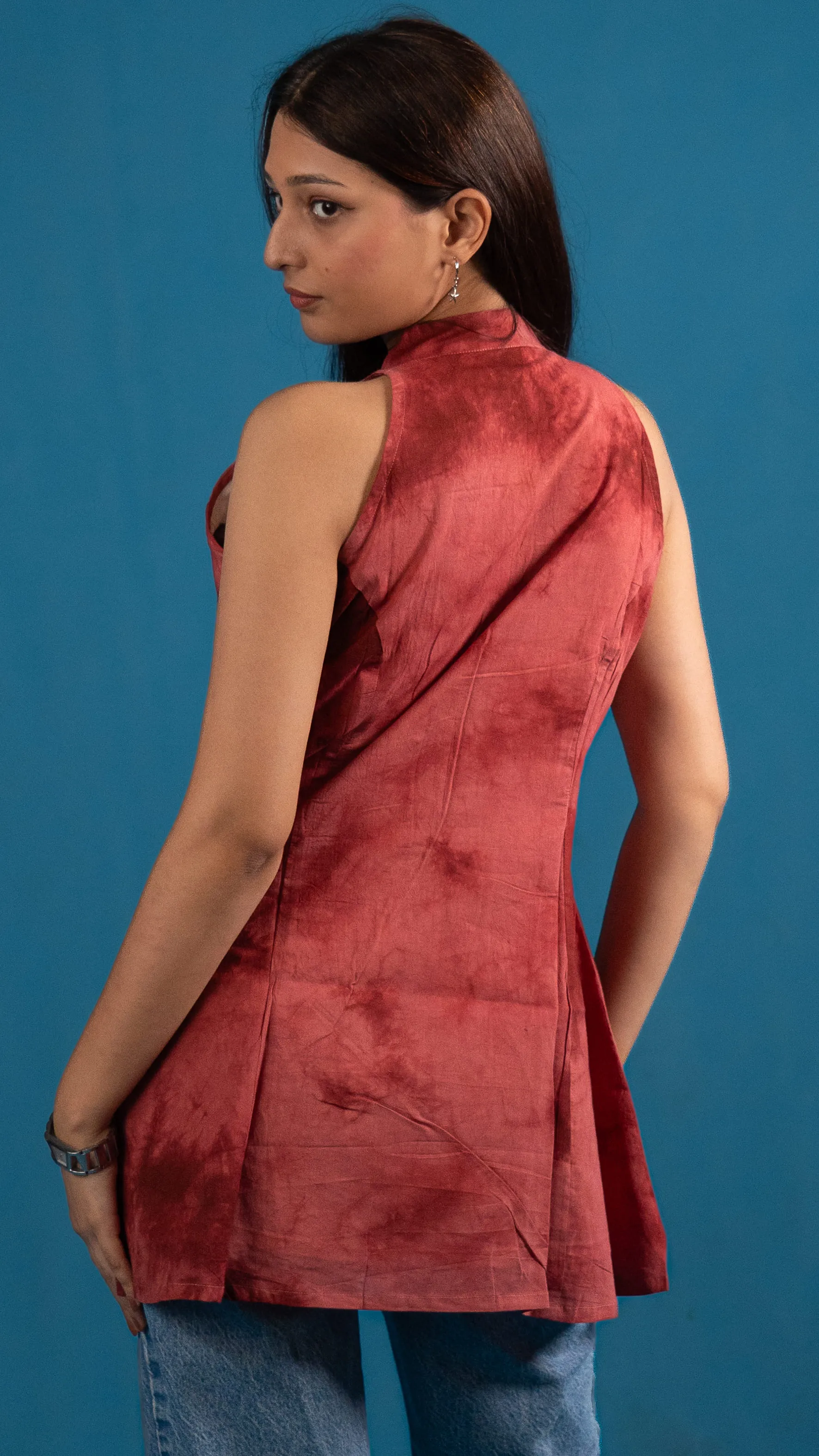 Back view of a red tie-dye sleeveless top for Indyvarna's collection photography.