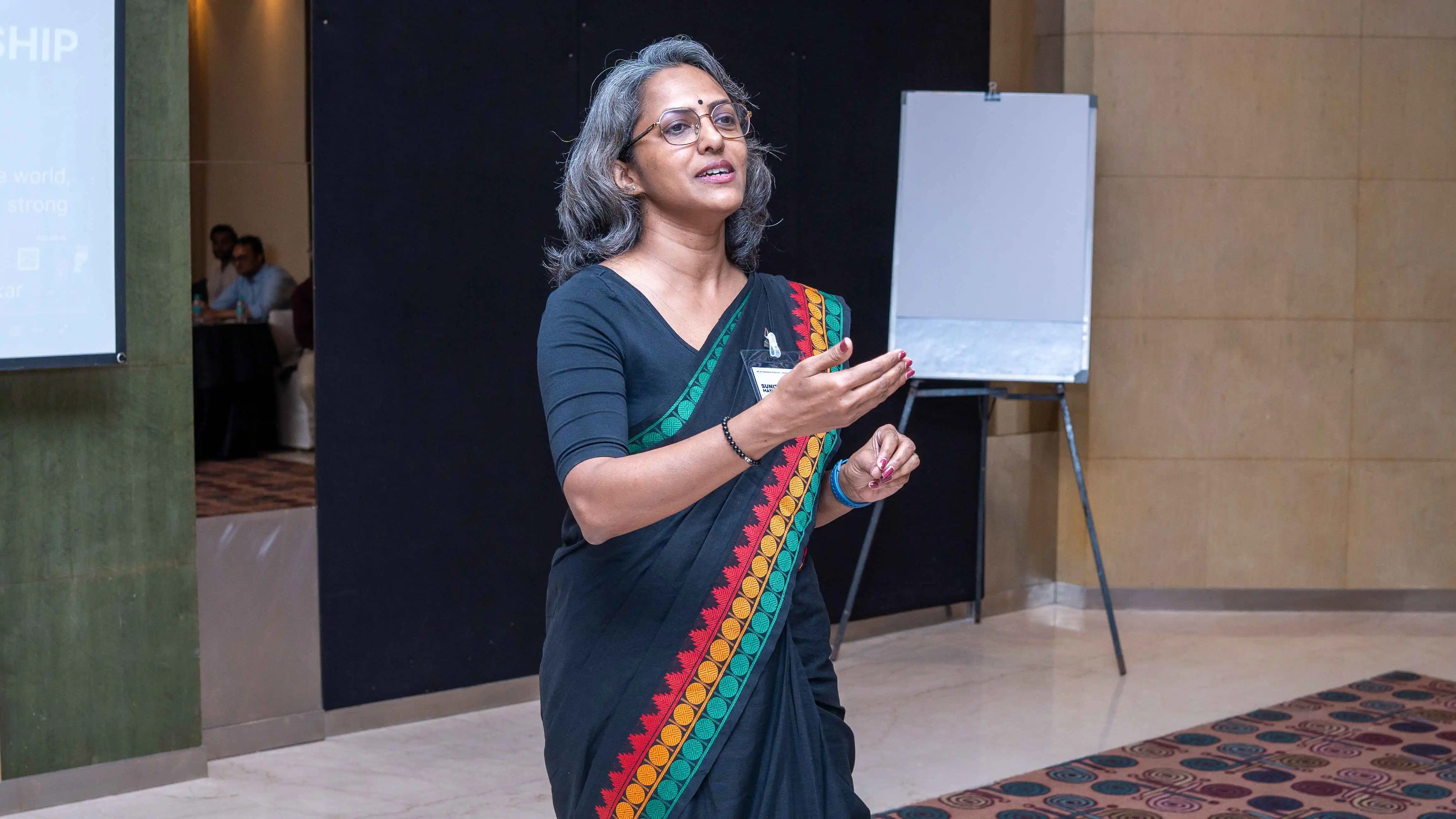 Woman beside a flip chart during a Skill Beyond Education event session.