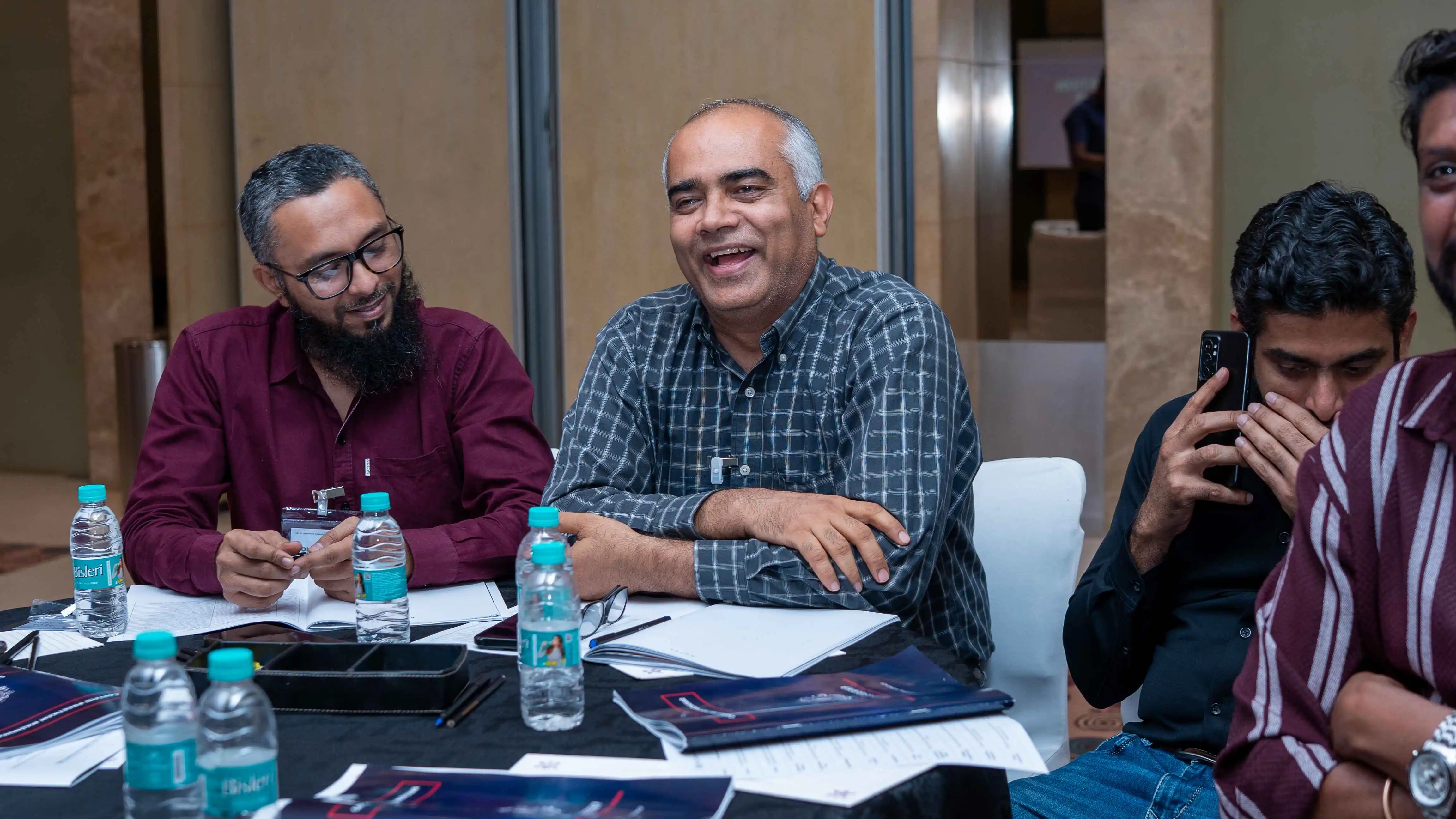 Participants at a discussion table during a Skill Beyond Education event.