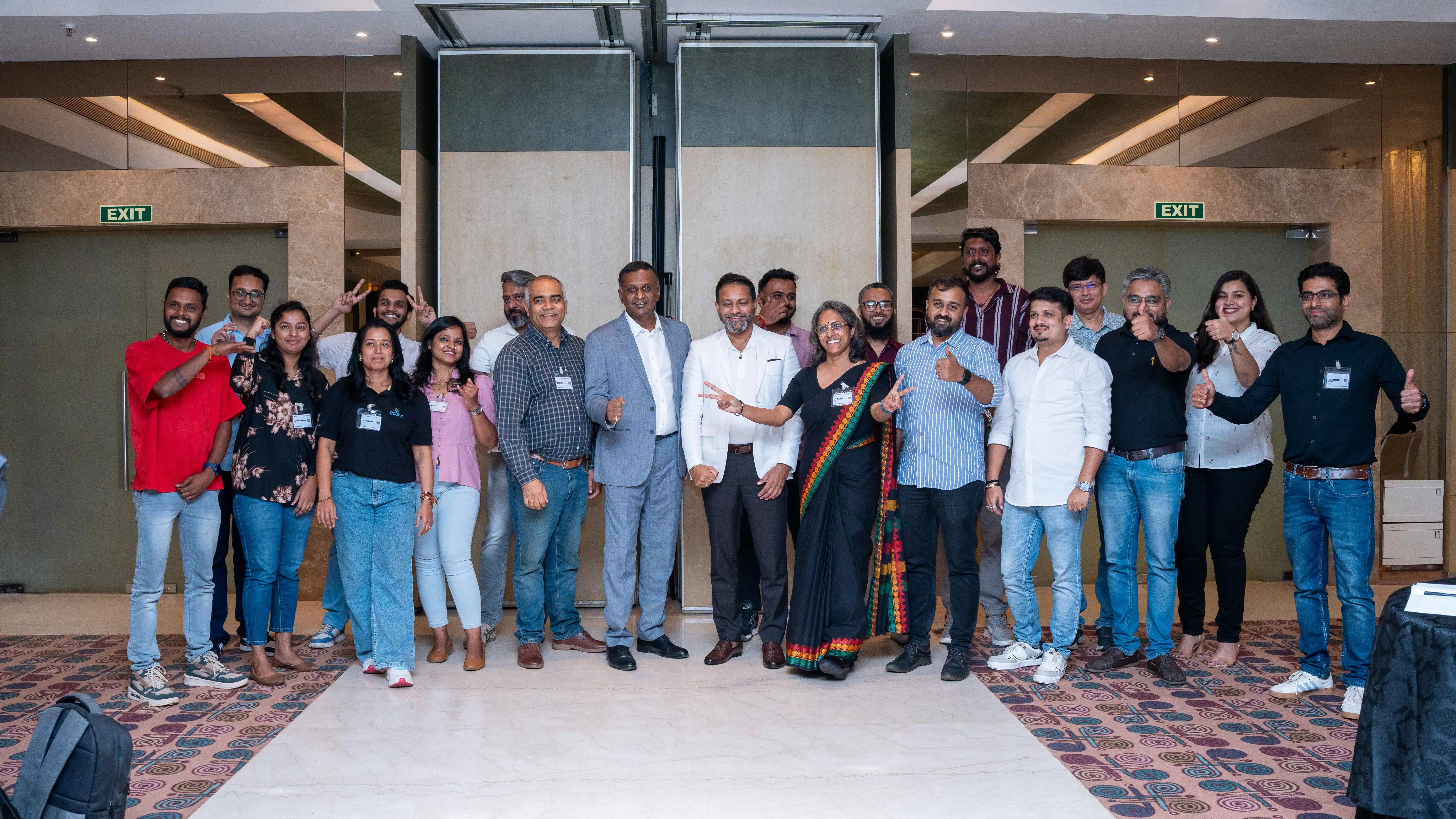 Event participants pose together indoors for Skill Beyond Education.